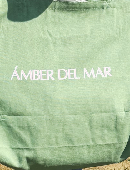 Large seafoam green canvas tote bag with light pink Ámber Del Mar logo.